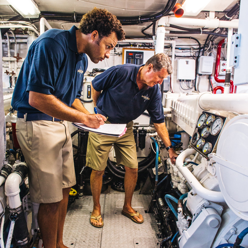 student and instructor examine engine